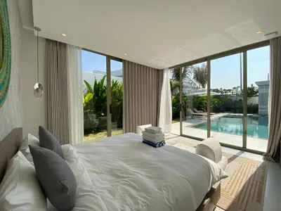 a bedroom with a large bed and a large window at 3bdr New Modern Pool Villa Bangtao ASH-05 in Ban Phru Champa