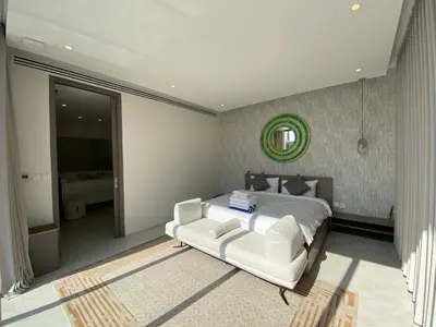 a bedroom with a white bed and a white couch at 3bdr New Modern Pool Villa Bangtao ASH-05 in Ban Phru Champa