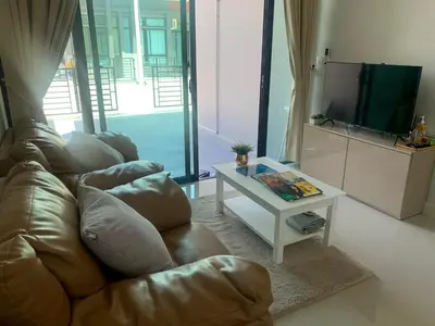 a living room with a couch and a table at 9169SiriplaceAirport in Ban Muang Mai (1)