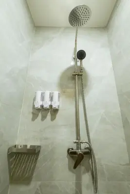 a shower in a bathroom with a shower head at Kewalin hostel in Phi Phi Don