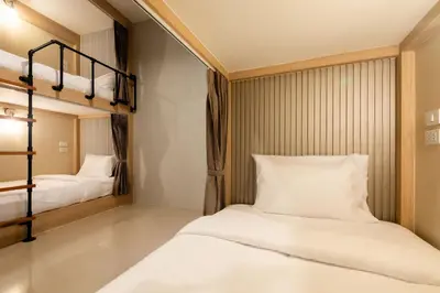 two beds in a room with two bunk beds at Kewalin hostel in Phi Phi Don
