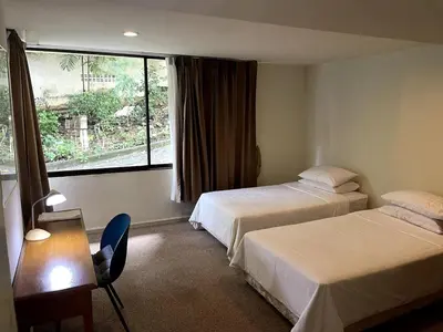 a hotel room with two beds and a window at 3-bed house with Private beach in Ban Ao Makham