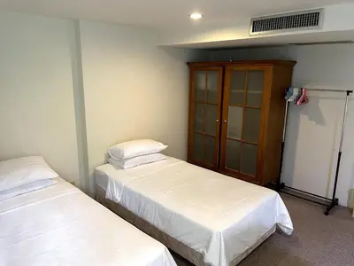 a room with two beds and a cabinet at 3-bed house with Private beach in Ban Ao Makham