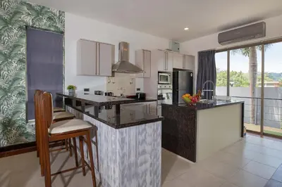 a kitchen with a large island in a room at Modern Comfort in Paradise - Villa Argent 6 with 3BR and Access to Tropical Pool in Thalang