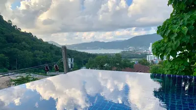 a swimming pool with a view of a mountain at Villa Patong 3 Chambres in Patong Beach