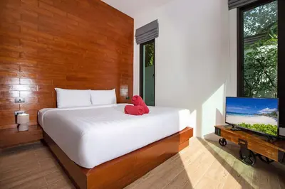 a red stuffed teddy bear sitting on a bed in a bedroom at Thai Balinese Villa Rico in Kamala 3BR, Private Pool in Kamala Beach