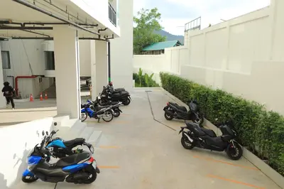 a group of motorcycles parked in a parking lot at Fantasea Kamala 1 BR Apartments Near Beach 212 in Kamala Beach