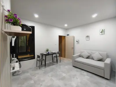 a living room with a couch and a table at 629 Home for rent, Rawai in Ban Saiyuan (1)