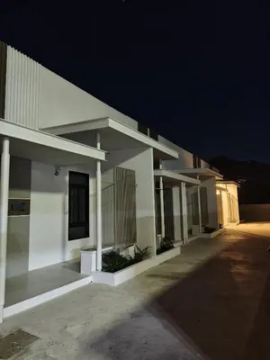 a large white building with a dark sky at 629 Home for rent, Rawai in Ban Saiyuan (1)
