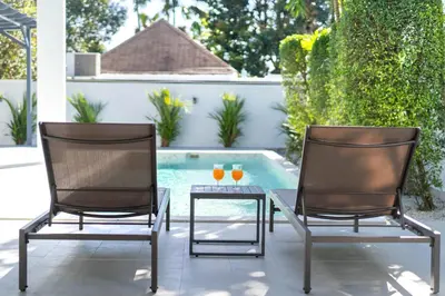two chairs and a glass table with drinks on it at Brand New Design 2BR Villa Indra with Oxygen Pool in Rawai Beach