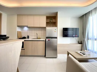 a kitchen with a stainless steel refrigerator at Fantasea Condo - Kamala in Kamala Beach
