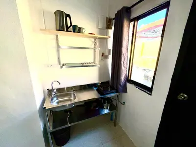 a small kitchen with a sink and a window at Patong Canal Villa 107 in Patong Beach