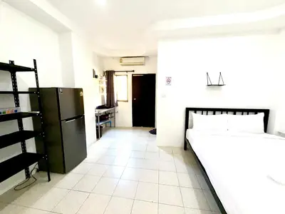 a kitchen with a black refrigerator and a white tile floor at Patong Canal Villa 107 in Patong Beach