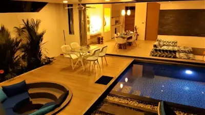 a living room and dining room with a swimming pool at 01 - Beach Villa Retreat in Nai Yang Beach
