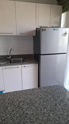 a kitchen with a white refrigerator and a sink at One bed Apartment Nai Yang in Nai Yang Beach