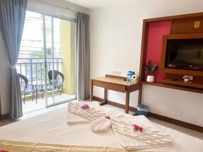 a hotel room with a bed with flowers on it at Arisa Hotel Patong Beach in Patong Beach