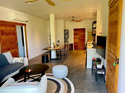 a living room with a couch and a table at Kata Luxury Apartment Matriochka 2BR En-suite in Kata Beach