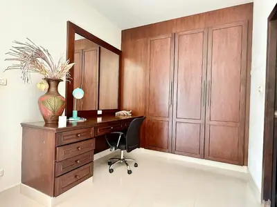 a home office with a wooden desk and a chair at Chuan Pool Villa Rawai Phuket in Rawai Beach
