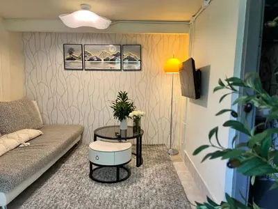 a living room with a couch and a table at Chill Apartment Lake View in Rawai Beach