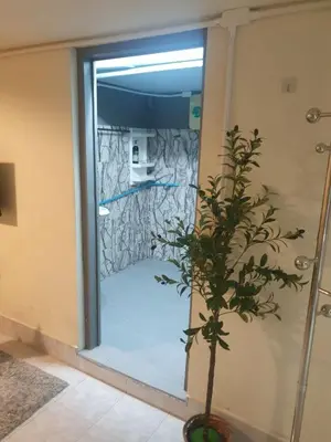 a bathroom with a door with a plant in front of it at Chill Apartment Lake View in Rawai Beach