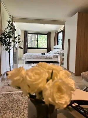 a vase with flowers in a room with a bedroom at Chill Apartment Lake View in Rawai Beach