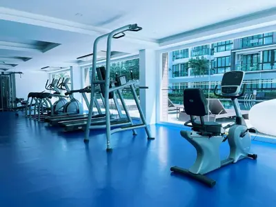 a gym with several treadmills and exercise bikes at Royal Lee Phuket Condominium AirportB in Ban Bo Han