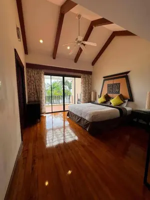 a large bedroom with a bed and a ceiling fan at Villa Laguna Bang Tao in Laguna Phuket