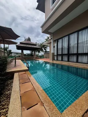 a swimming pool in front of a building at Villa Laguna Bang Tao in Laguna Phuket