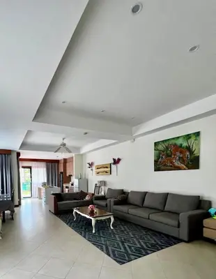 a large living room with couches and a table in it at Villa Laguna Bang Tao in Laguna Phuket