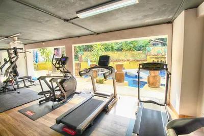 a gym with several treadmills and elliptical machines at Bay Shore Ocean View by Get A Rent Phuket in Patong Beach