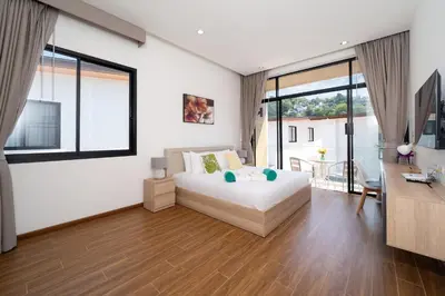 a white bedroom with a bed and a desk at Goldena Twin Project - 3 Bedrooms Pool Villa in Kamala Beach