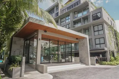 an apartment building with a large glass door at Diamond Resort in Bang Tao Beach