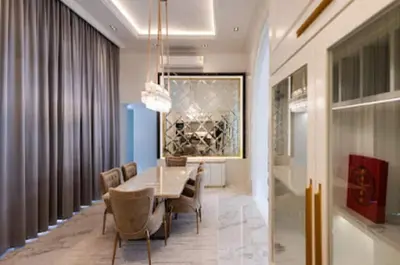 a dining room with a table and chairs at Gold Chariot in Laguna Phuket