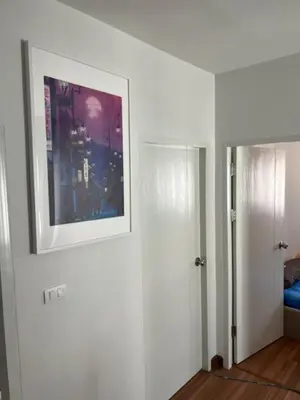 a white room with a picture on the wall at Villa PalmSprings in Ban Phak Chit