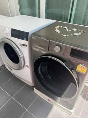 a washing machine is sitting next to a washer at Villa PalmSprings in Ban Phak Chit