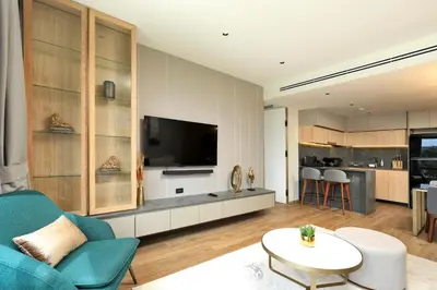 a living room with a blue couch and a tv at 2bdr Apartment with Bath near Bangtao Beach C512 in Laguna Phuket