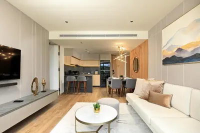 a living room with a white couch and a table at 2bdr Apartment with Bath near Bangtao Beach C512 in Laguna Phuket