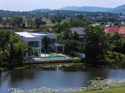 an aerial view of a house next to a lake at Lumière Villas Phuket - Golfside Retreat in Laguna in Laguna Phuket