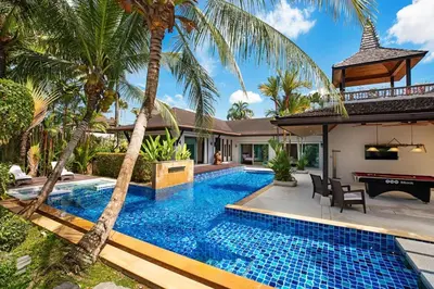 a swimming pool in the backyard of a villa at Luxury 5 Bedroom Staffed Botanica Villas in Ban Phru Champa