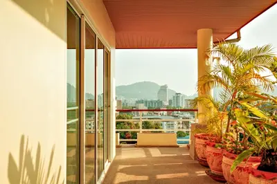 a balcony with plants and a view of the city at Over the Moon villa in Patong Beach