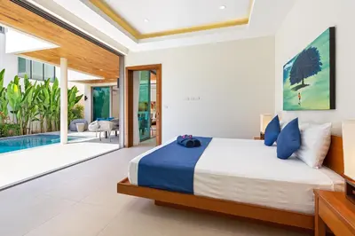 a bedroom with a bed and a swimming pool at Modern Thai-Balinese 2-Storey Pool Villa Kael in Ka Villas Residence, 500m from Famous Rawai Beach Seafood Market in Rawai Beach