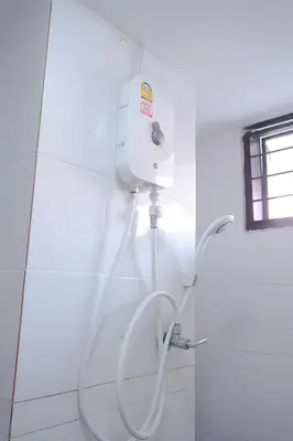 a white shower in a bathroom with a hose at XX GO INN Phuket Patong Beach in Patong Beach