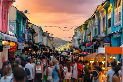 a crowd of people walking down a crowded city street at XX GO INN Phuket Patong Beach in Patong Beach