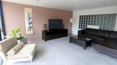 a living room with a couch and a tv at Villa Loma & Patong 6 chambres in Patong Beach