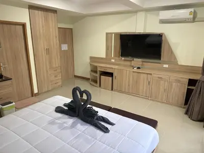 a room with a bed with a black animal on the floor at Sumaka Hotel Karon in Kata Beach