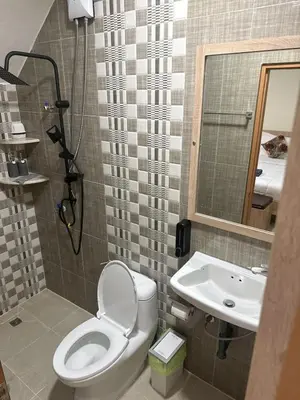 a bathroom with a toilet and a sink at Sumaka Hotel Karon in Kata Beach