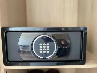 a small black microwave sitting on top of a shelf at Laya Residence Memoory Layan in Ban Na Bon