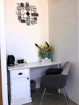 a white desk with a chair and a plant at 20 - Tranquil Retreat near Marriott Naiyang Beach in Nai Yang Beach