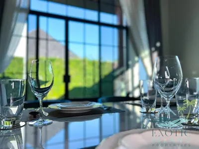 a table with wine glasses on a table with a window at Stylish 3BR Private Pool Villa Bangtao Beach in Ban Pak Lak