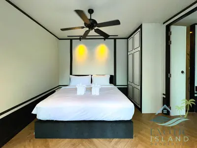 a bedroom with a white bed with a ceiling fan at Stylish 3BR Private Pool Villa Bangtao Beach in Ban Pak Lak